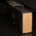 Old Kodak camera box partially opened, showing aged yellow label with faded handwritten writing from 1923.