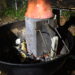 Charcoal grill with a chimney starter lit at night during a late-night cookout